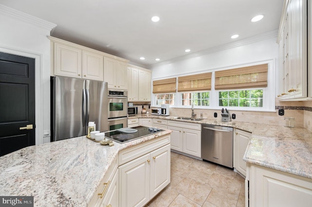 kitchen featuring appliances with stainless steel finishes, a sink, light tile patterned floors, light stone counters, and ornamental molding
