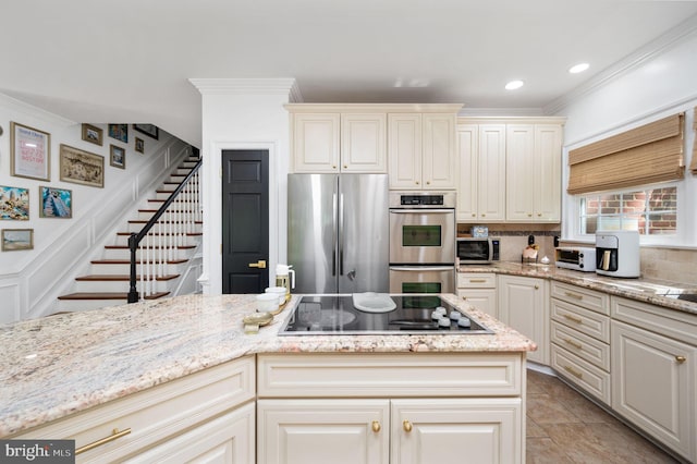 kitchen featuring ornamental molding, decorative backsplash, light stone countertops, and stainless steel appliances