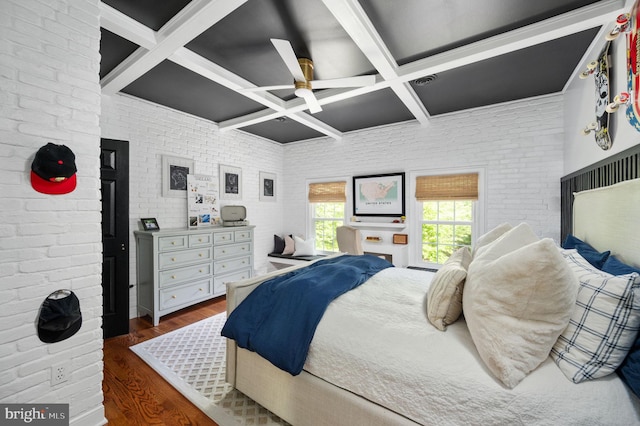 bedroom with ceiling fan, brick wall, beam ceiling, dark wood-style floors, and coffered ceiling