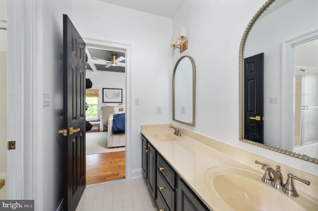 ensuite bathroom featuring walk in shower, a sink, tile patterned flooring, double vanity, and ensuite bathroom