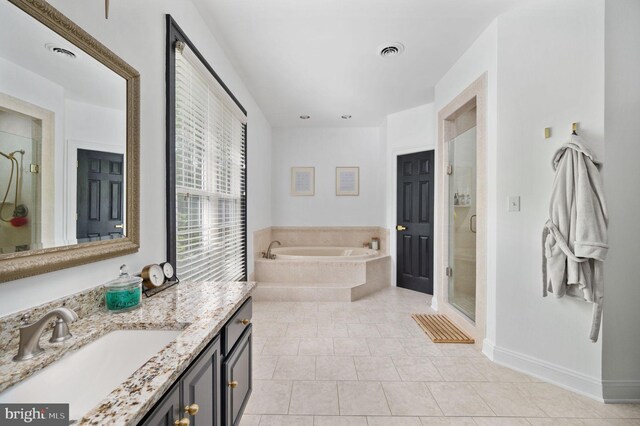 bathroom featuring visible vents, vanity, a garden tub, and a shower stall
