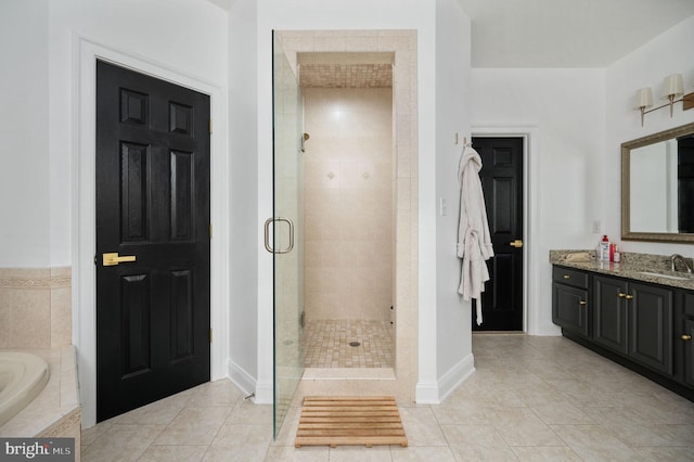 full bath featuring vanity, baseboards, a bath, tile patterned floors, and a shower stall
