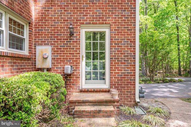 property entrance featuring brick siding
