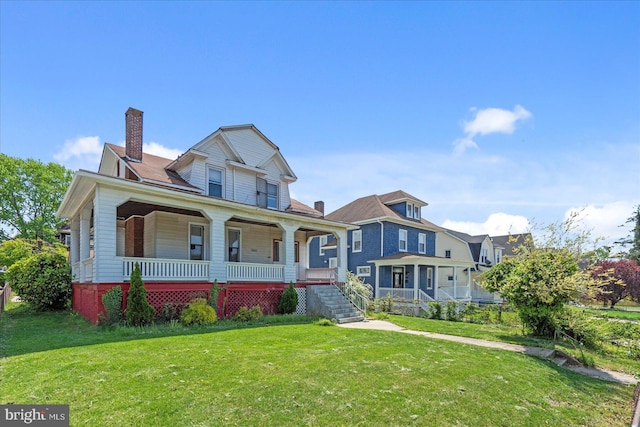 view of front facade featuring covered porch, a chimney, and a front lawn