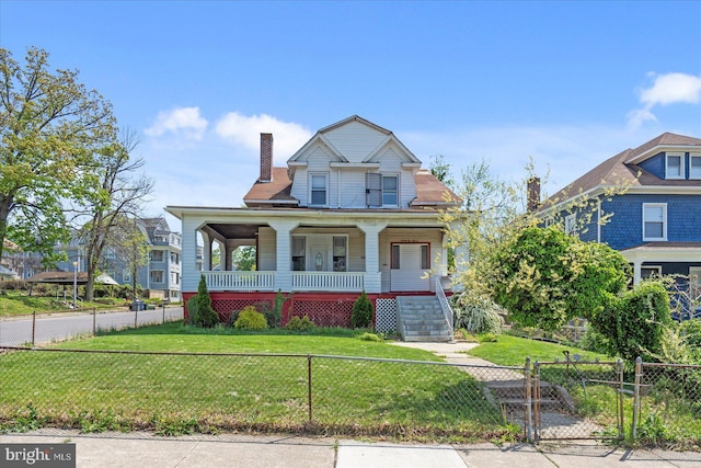 view of front of home featuring a porch, a fenced front yard, a front yard, and a chimney