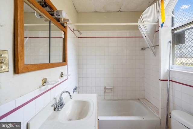 2611 Elsinore Ave, Baltimore, MD 21216 - bathroom with shower / bathtub combination, toilet, tile walls, and vanity
