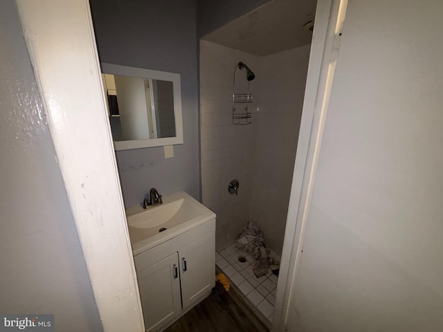 bathroom with vanity and a tile shower