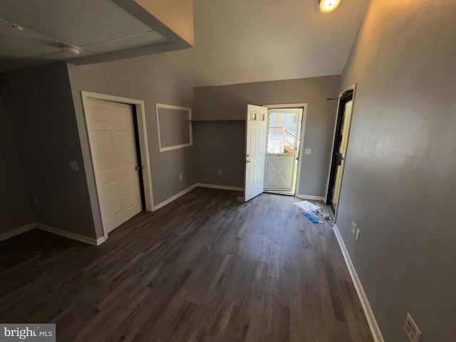 entrance foyer with baseboards, dark wood finished floors, and lofted ceiling