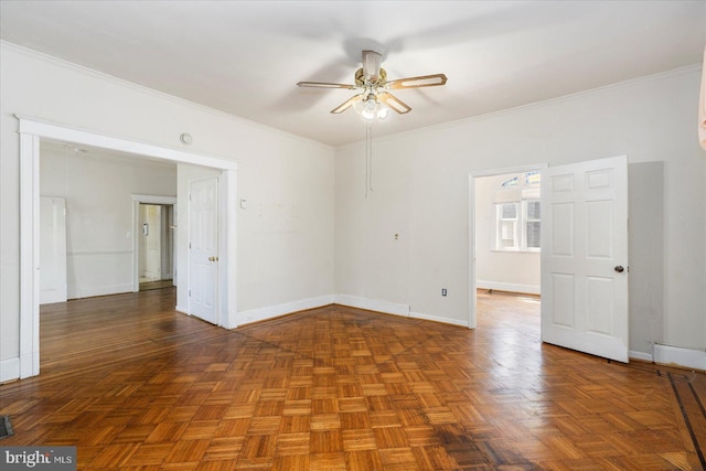spare room with baseboards, a ceiling fan, visible vents, and ornamental molding