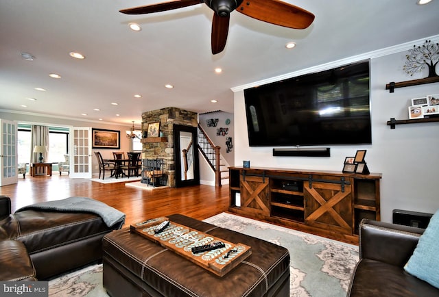living area featuring recessed lighting, wood finished floors, stairs, ceiling fan, and crown molding