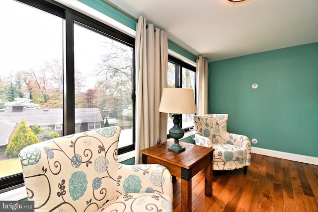 sitting room featuring hardwood / wood-style flooring and baseboards
