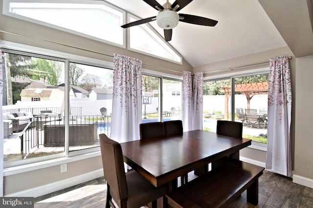 sunroom / solarium with wood finished floors, vaulted ceiling, and baseboards