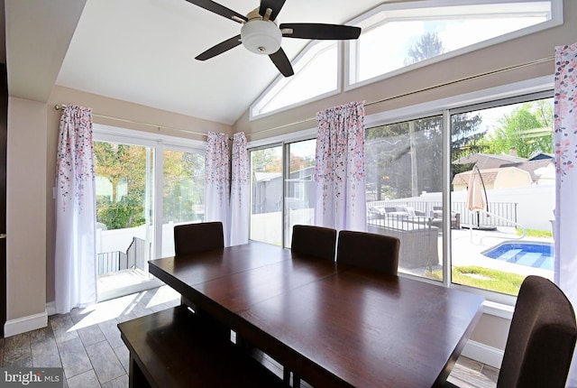 sunroom / solarium featuring lofted ceiling and baseboards