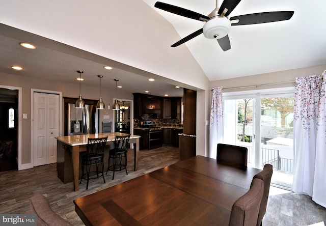 dining space with recessed lighting, a ceiling fan, and high vaulted ceiling