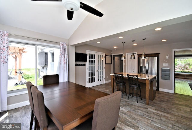 dining room featuring lofted ceiling, french doors, ceiling fan, and dark wood finished floors