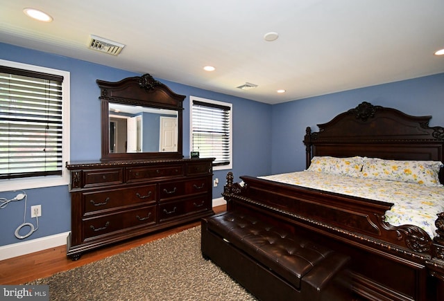 bedroom with recessed lighting, visible vents, baseboards, and dark wood-type flooring