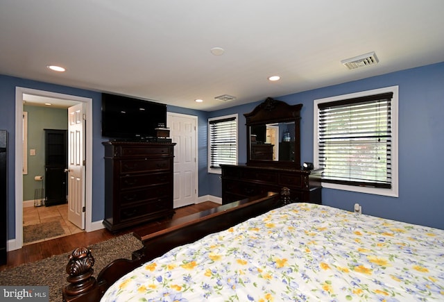 bedroom featuring recessed lighting, visible vents, and wood finished floors