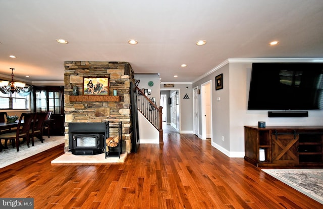 unfurnished living room featuring ornamental molding, recessed lighting, an inviting chandelier, and wood finished floors