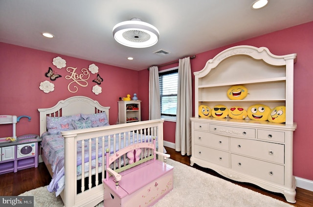 bedroom with baseboards, visible vents, wood finished floors, and recessed lighting