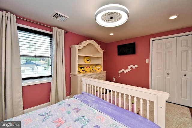 carpeted bedroom with visible vents, recessed lighting, and a closet
