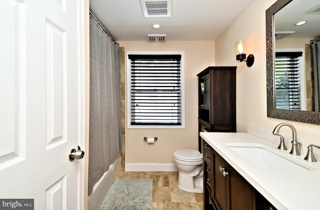 bathroom featuring vanity, toilet, visible vents, and baseboards
