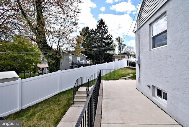 exterior space with a fenced backyard and a patio area