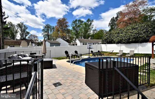 view of pool with an outdoor hangout area, a fenced in pool, a fenced backyard, and a patio area