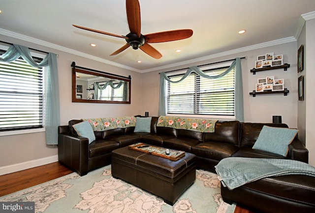 living area featuring ornamental molding, ceiling fan, wood finished floors, and baseboards