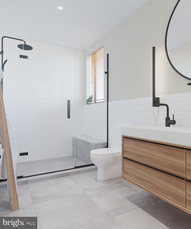 bathroom with tile walls, a stall shower, toilet, and vanity
