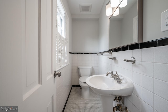 403 Thomas St, Alexandria, VA 22302 - bathroom with visible vents, tile walls, tile patterned flooring, a wainscoted wall, and toilet