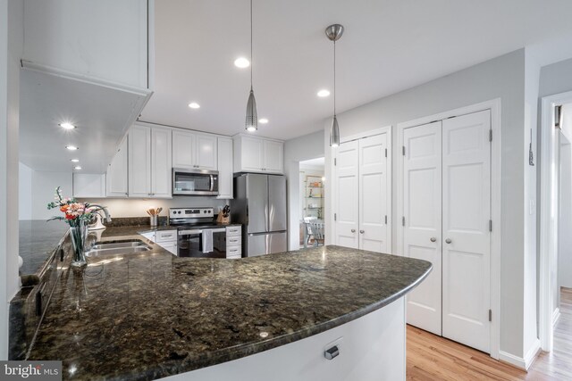 403 Thomas St, Alexandria, VA 22302 - kitchen with appliances with stainless steel finishes, a sink, light wood finished floors, white cabinetry, and recessed lighting