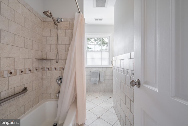 403 Thomas St, Alexandria, VA 22302 - bathroom featuring tile walls, shower / bath combo with shower curtain, tile patterned floors, and visible vents