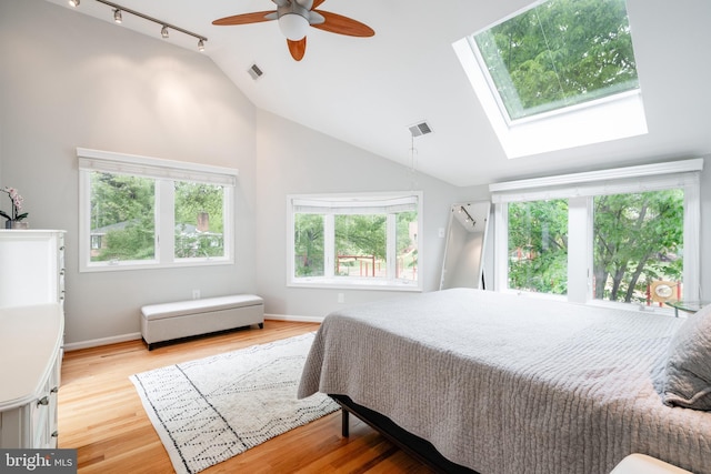 403 Thomas St, Alexandria, VA 22302 - bedroom with visible vents, track lighting, wood finished floors, and vaulted ceiling with skylight