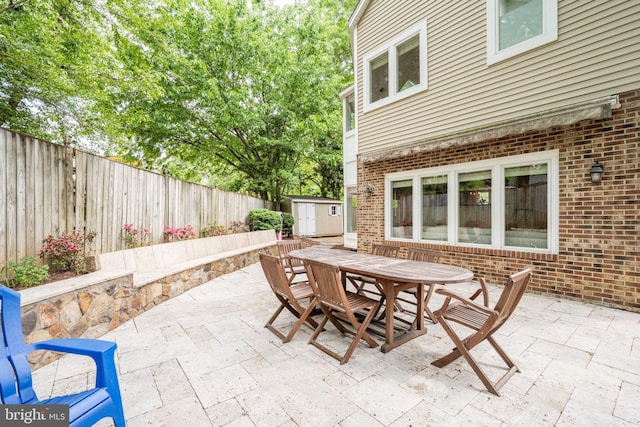 403 Thomas St, Alexandria, VA 22302 - view of patio / terrace featuring an outdoor structure, a fenced backyard, a storage shed, and outdoor dining space