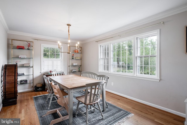 403 Thomas St, Alexandria, VA 22302 - dining space with crown molding, baseboards, a chandelier, and light wood-style floors