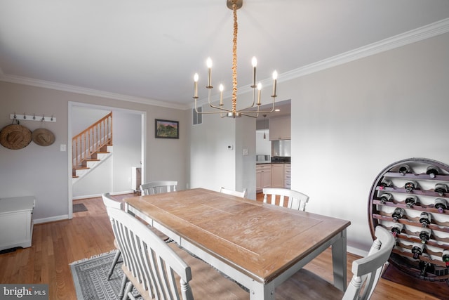 403 Thomas St, Alexandria, VA 22302 - dining area featuring crown molding, an inviting chandelier, stairs, baseboards, and light wood-style floors