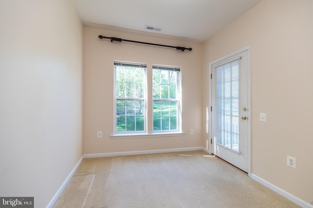 doorway with baseboards, visible vents, and a healthy amount of sunlight