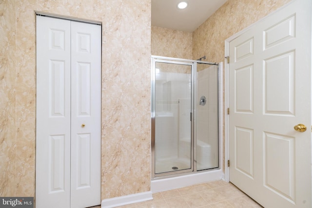 full bath featuring a closet, recessed lighting, tile patterned floors, and a shower stall