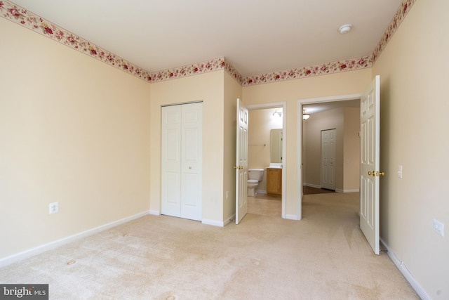 unfurnished bedroom with baseboards, a closet, and light colored carpet