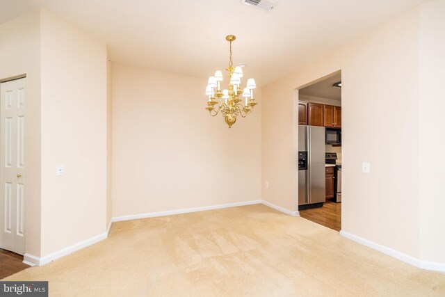 unfurnished dining area featuring baseboards, an inviting chandelier, light carpet, and visible vents