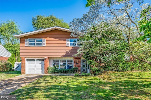 view of front facade with a front lawn, concrete driveway, an attached garage, and brick siding