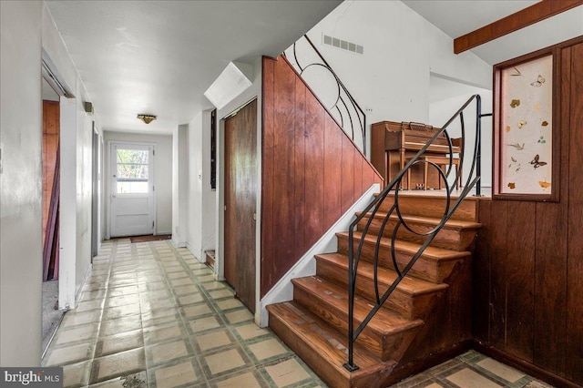 stairway featuring tile patterned floors and visible vents