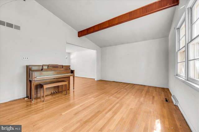 bonus room featuring visible vents, hardwood / wood-style floors, and vaulted ceiling with beams
