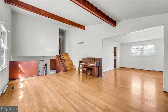 unfurnished living room with stairway, beam ceiling, a chandelier, visible vents, and light wood-style flooring
