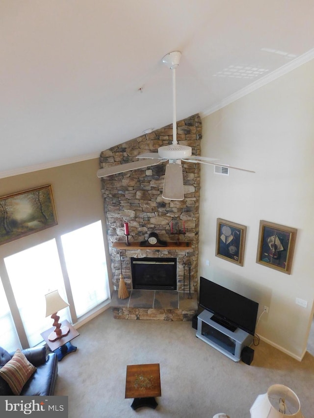 living area with visible vents, carpet flooring, a fireplace, and ornamental molding