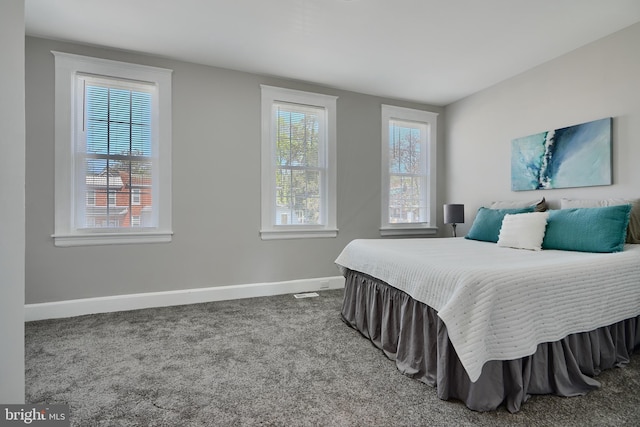 bedroom featuring baseboards and carpet