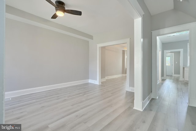 interior space with light wood-type flooring, a ceiling fan, and baseboards