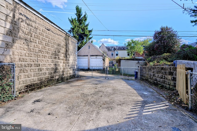 exterior space featuring driveway, a gated entry, and a gate
