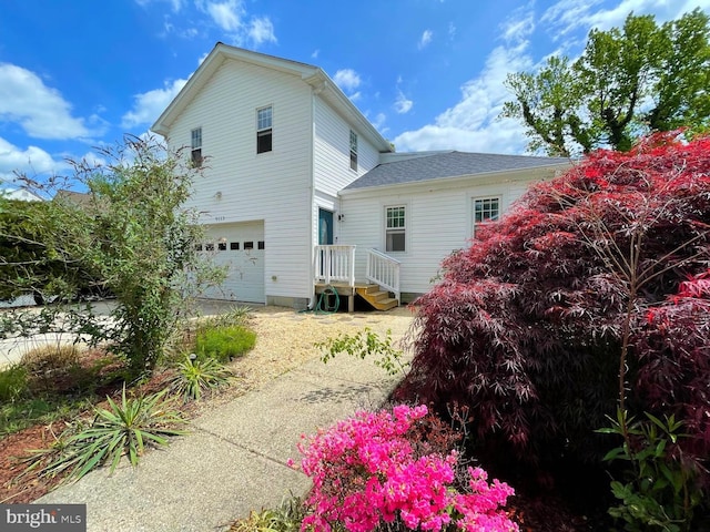 back of house featuring a garage