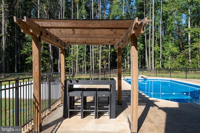 view of swimming pool featuring fence, a patio area, a pergola, and a diving board